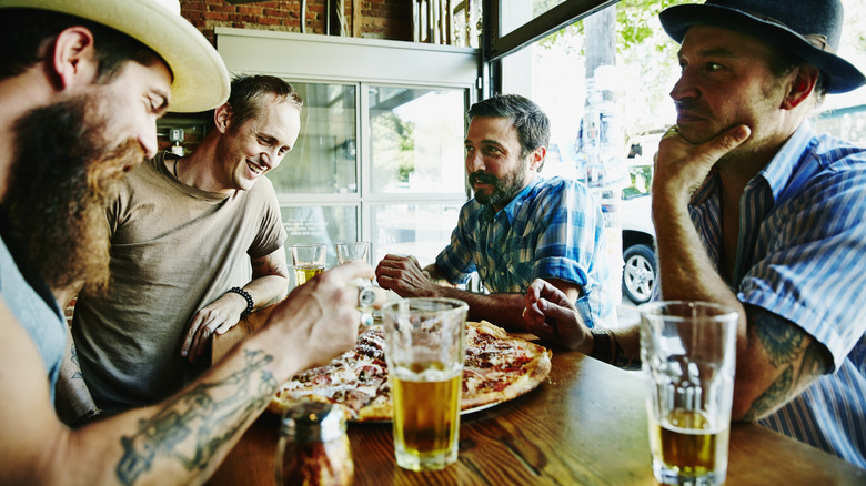 Group of men with pizza and beer