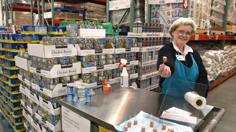 A Costco employee offers free samples.