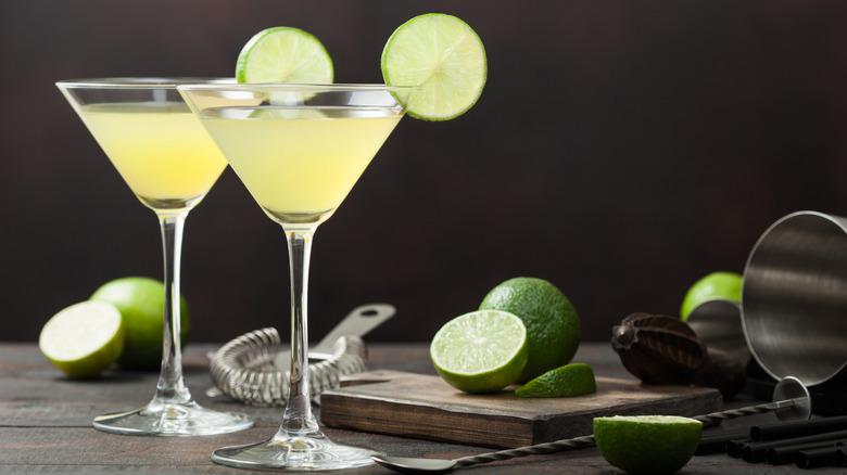 Two gimlet cocktails and limes