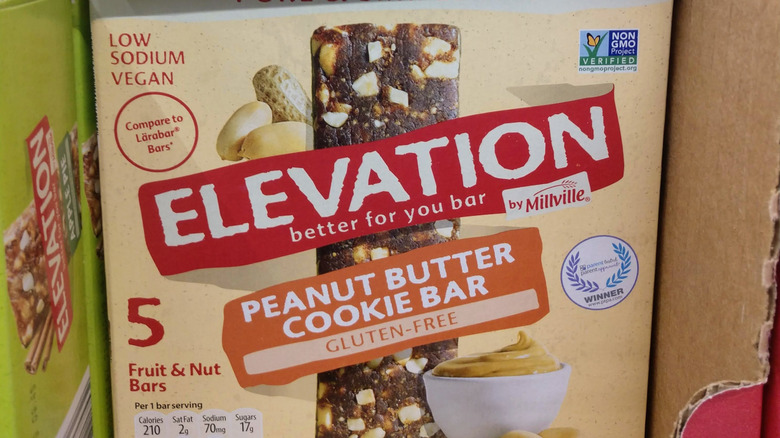 A close-up of a box of Elevation by Millville Peanut Butter Cooke bars with a picture of the bar on the front