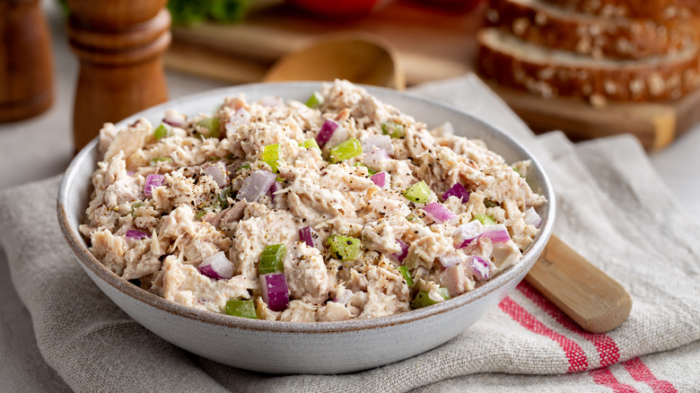 A bowl of creamy tuna salad on a table.
