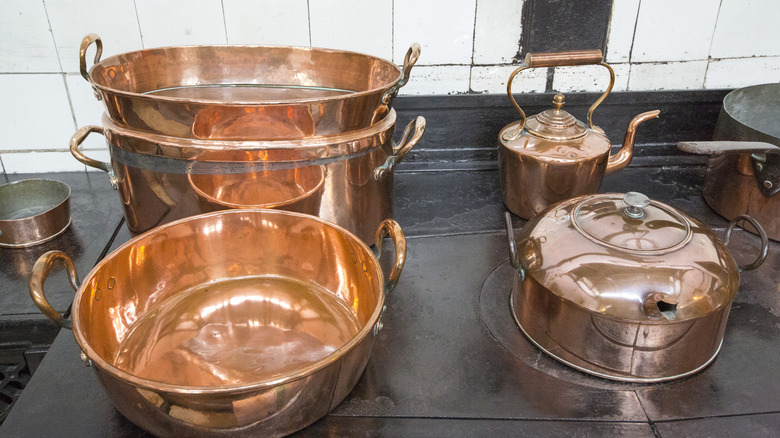 Copper pots and copper teakettle on stovetop
