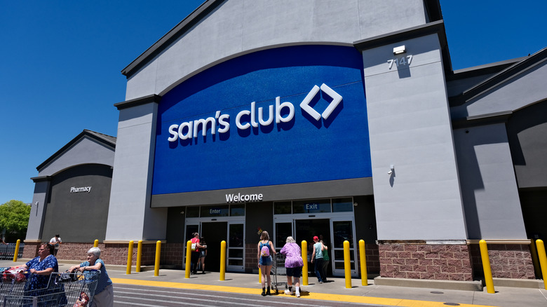 Entrance to Sam's Club with older shoppers pushing carts in front