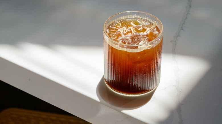 a glass of cold brew lit by the sun