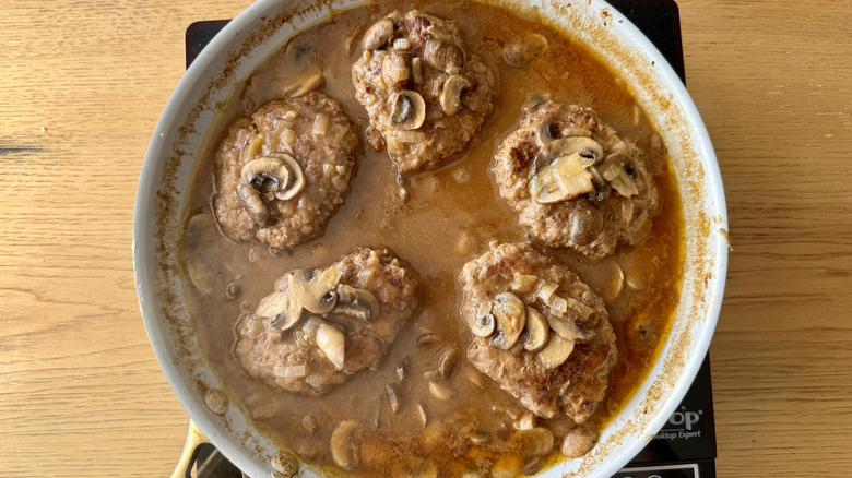Salisbury steaks simmering in gravy
