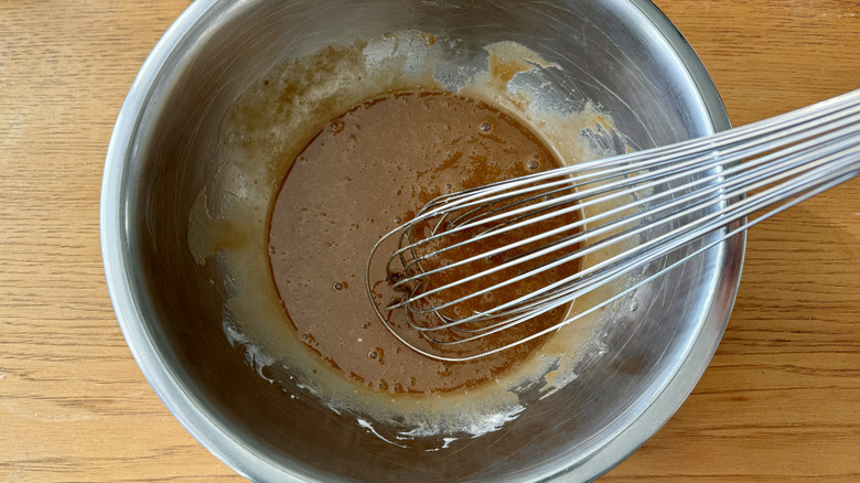 Whisking wet batter ingredients in bowl