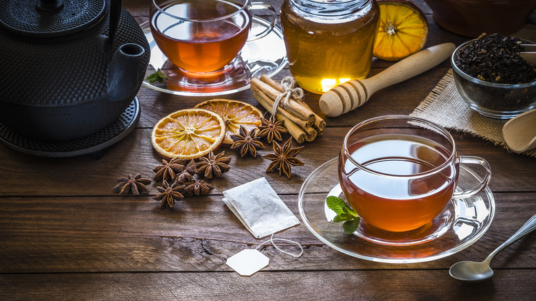 Assorted teas and honey on table.