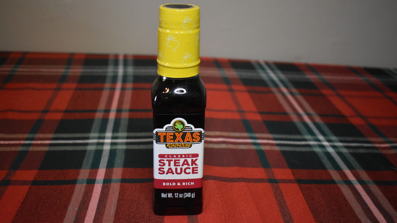 small dark bottle with yellow top